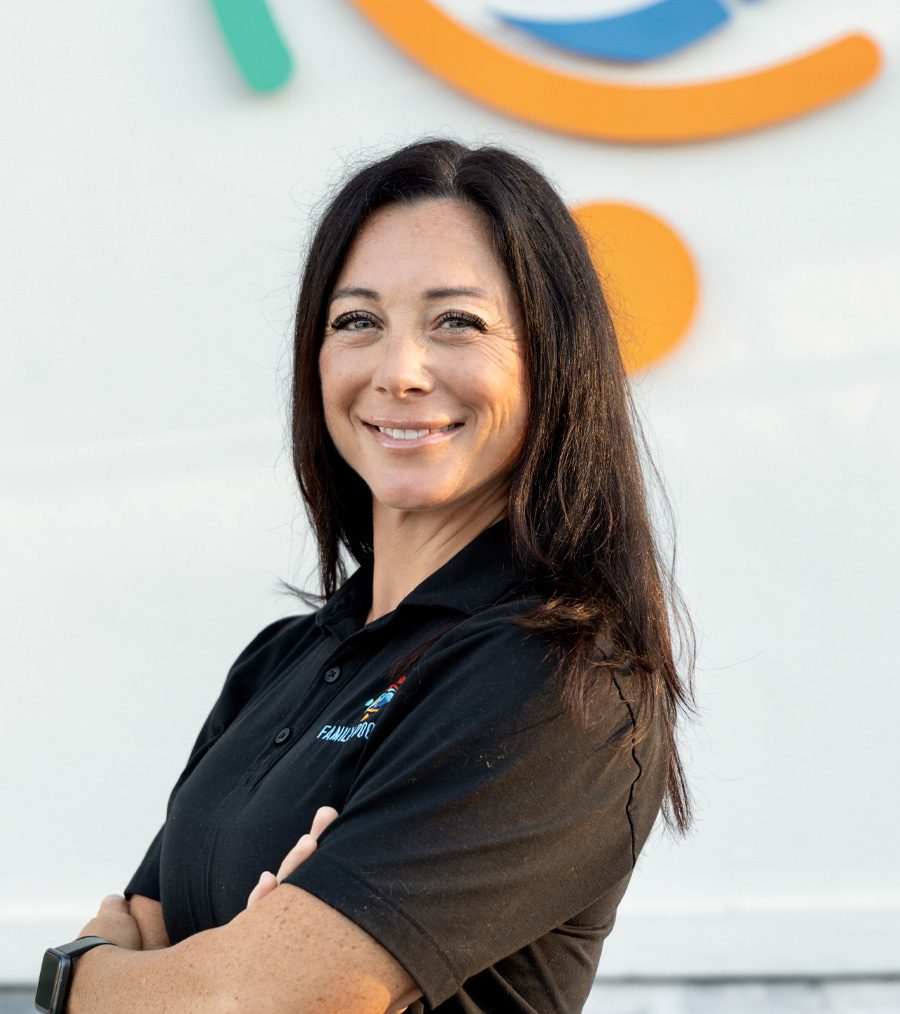 Tabitha Wheeler, Superintendent at Florida Family Pools, smiling confidently in a black polo shirt with the company logo, against a light background with colorful design elements.