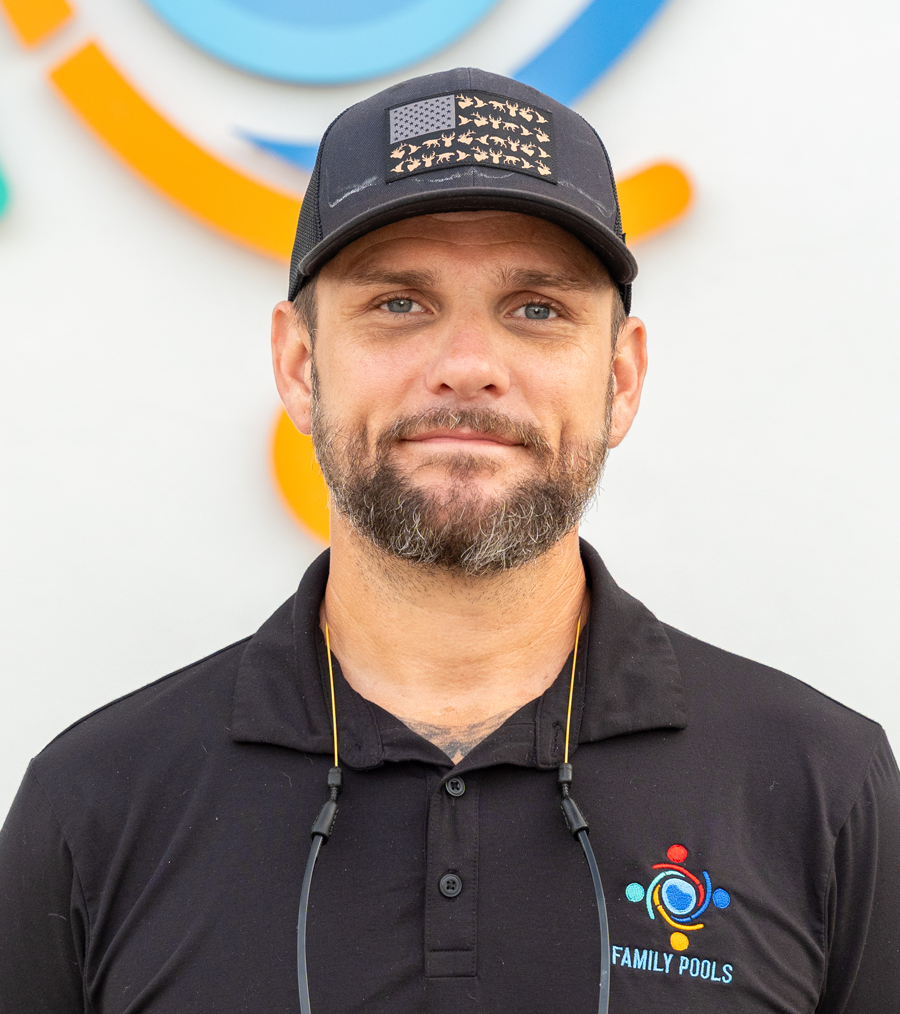 Scott Marx, Florida Family Pools superintendent, wearing a patriotic hat and company polo shirt.
